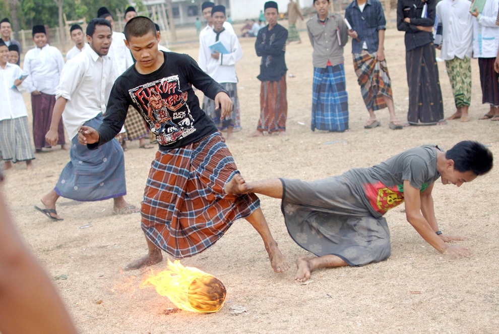 ***EXCLUSIVE*** KEDIRI, INDONESIA - OCTOBER 7: Students play Fire Football at the boarding school Lirboyo on October 7, 2012 in Kediri, Indonesia. THE PREMIER League boasts some of the hottest stars in the world &ndash; but they&rsquo;ve got nothing on these fiery