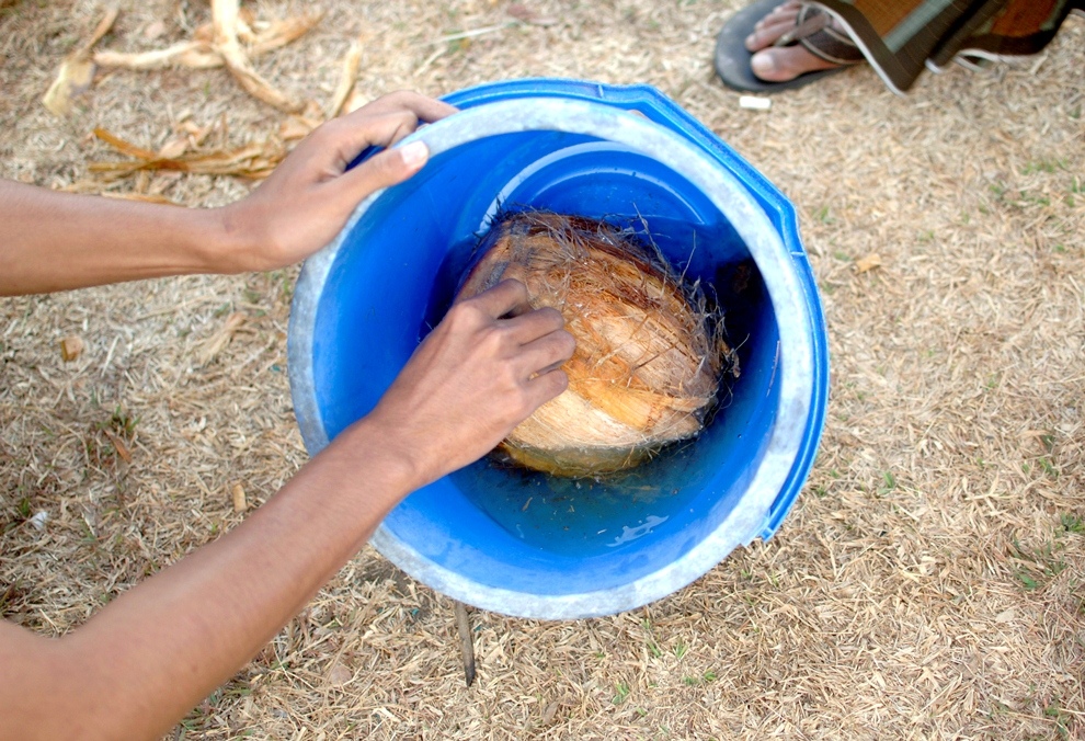 ***EXCLUSIVE*** KEDIRI, INDONESIA - OCTOBER 3: Student soak coconuts in a bucket of kerosene before playing Fire Football at the boarding school Lirboyo on October 3, 2012 in Kediri, Indonesia. THE PREMIER League boasts some of the hottest stars in the