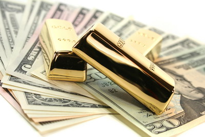 Gold bullion on dollar bills